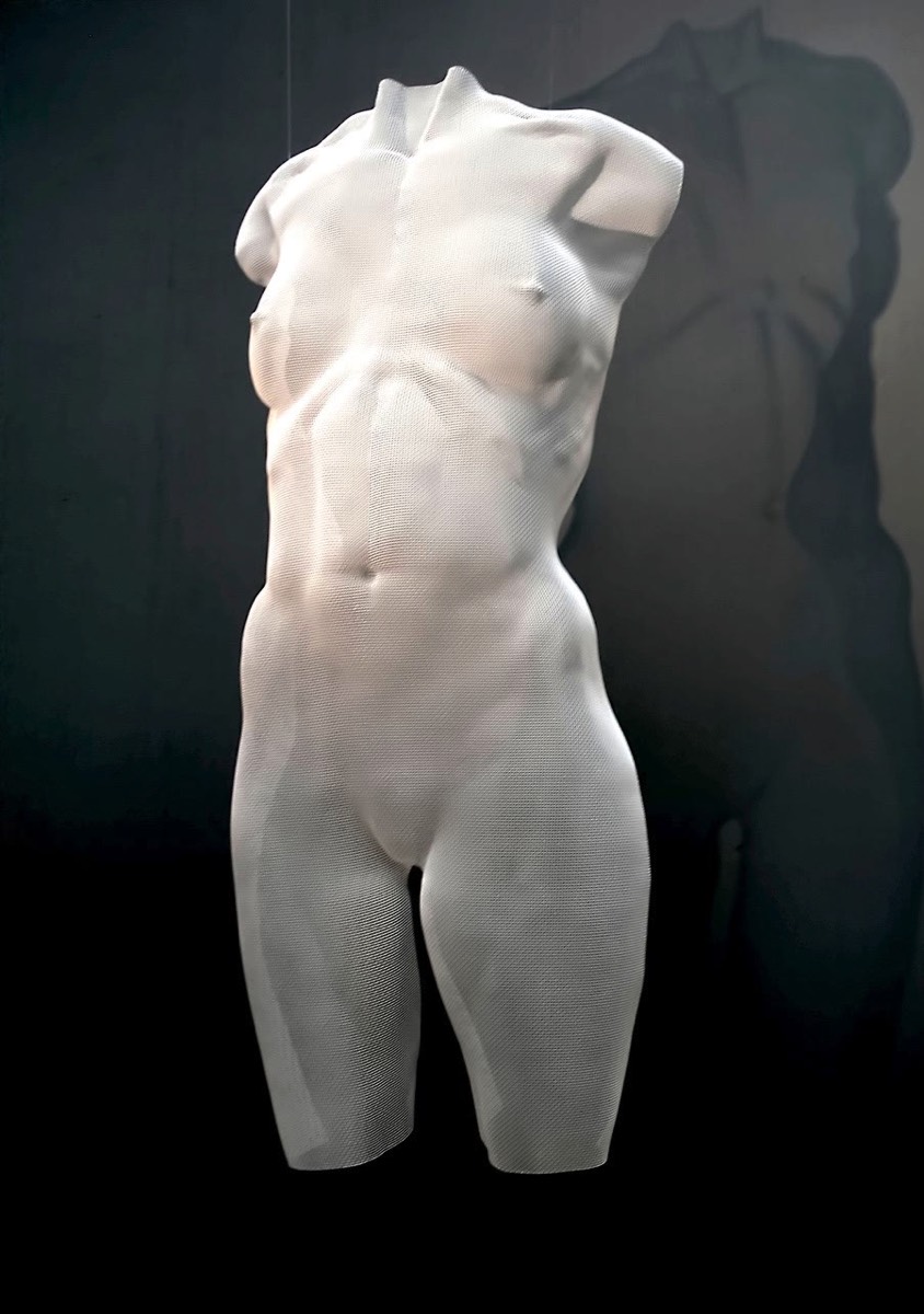 A female torso sculpture looks like marble but made by wire