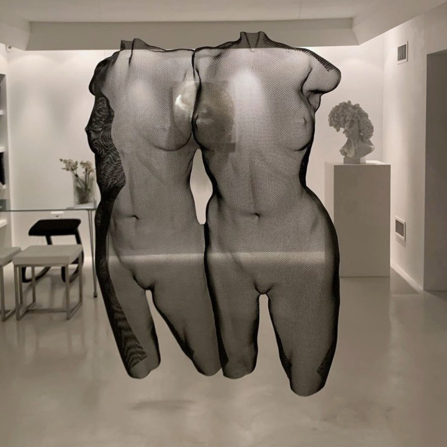 Two nude female busts as a transparent artwork at an art gallery in Padova