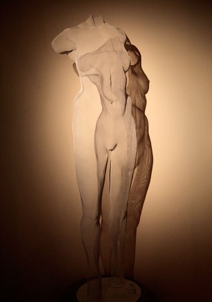 white sculpture of a nude girl in steel-mesh