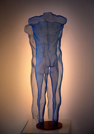 blue figure of a nude boy in metal mesh