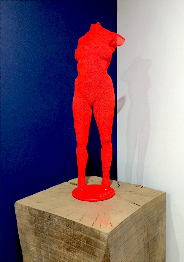 A red figurative sculpture on a wooden base - Begbie Owner about wire-mesh art