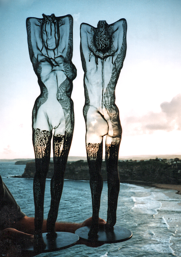 Transparent nude female figures with stockings made from wire in front of Sydney beach