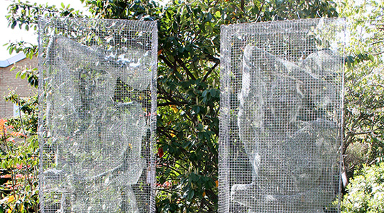 Large wire sculptures in cages presented in the garden