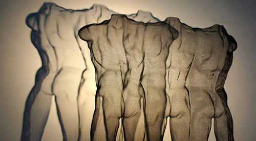 Figurative transparent sculpture of male figures with shadow projection